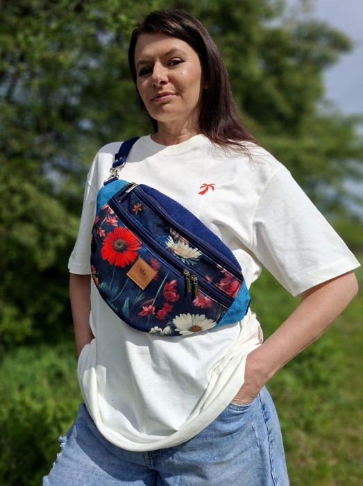 Granatowa nerka w kwiaty – stylowa i pojemna saszetka na pas lub przez ramię. Wytrzymały materiał, praktyczne kieszenie i wygodny zamek. Idealna na spacer, podróż i codzienne wyjścia. Modny dodatek łączący funkcjonalność z kobiecym stylem. 