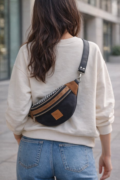 Zamszowa nerka w czarno-brązowej kolorystyce to stylowy i funkcjonalny dodatek na co dzień. Minimalistyczny design, regulowany pasek i wysokiej jakości materiały sprawdzą się w miejskich stylizacjach.